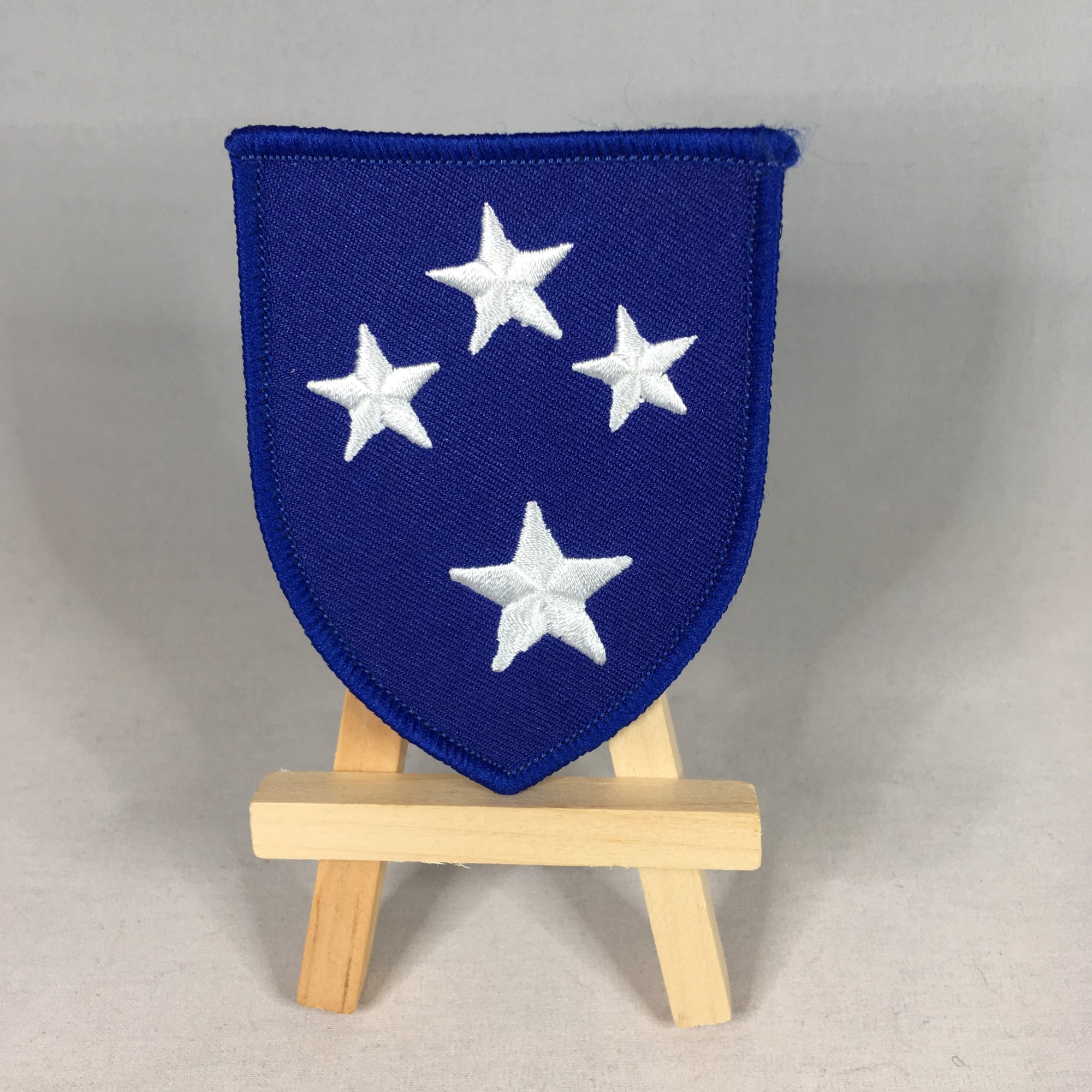 Blue shoulder patch of the 23rd Infantry Division, Americal, bearing the four stars of the Southern Cross