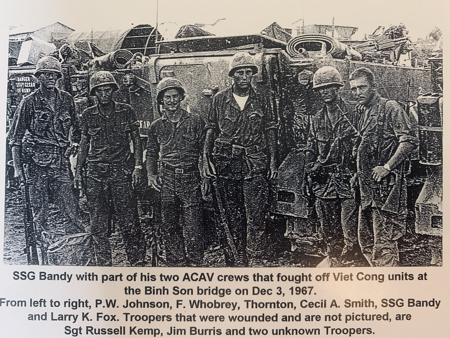 A reproduced historical photograph of SSG Bandy and members of two ACAV crews after the Binh Son Bridge action