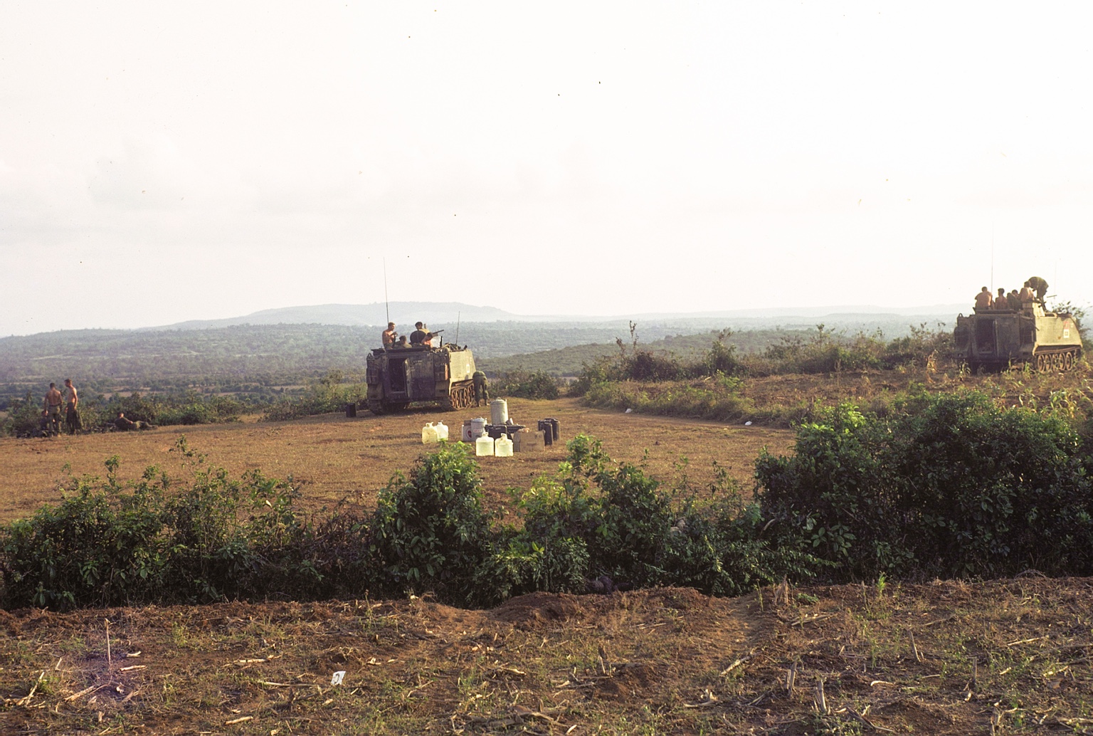 Two H Troop ACAVs and troopers at a field position overlooking the Vietnamese countryside