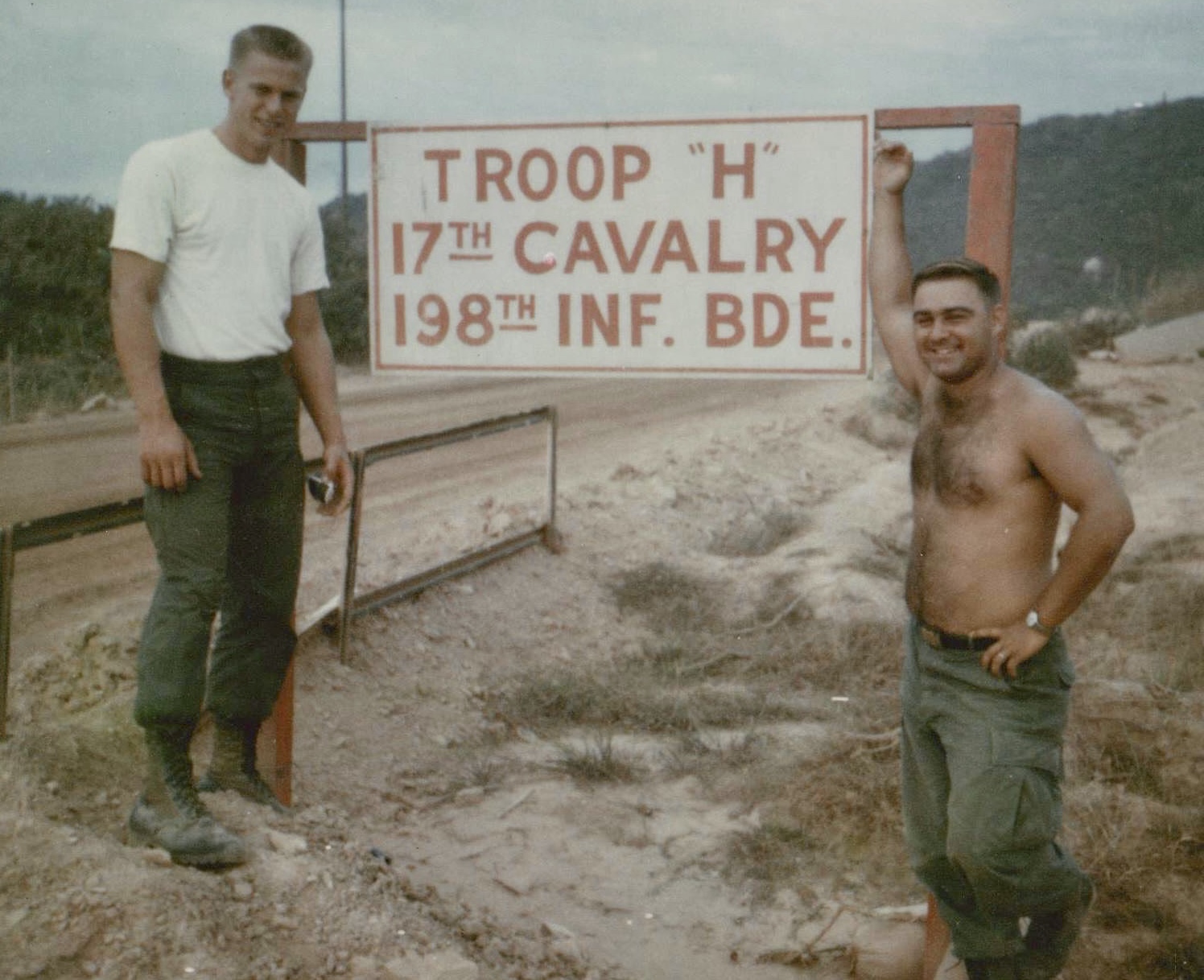 Ardie Ben Frantzich, known as Swede, and an unidentified trooper beside the H Troop 17th Cavalry 198th Infantry Brigade sign