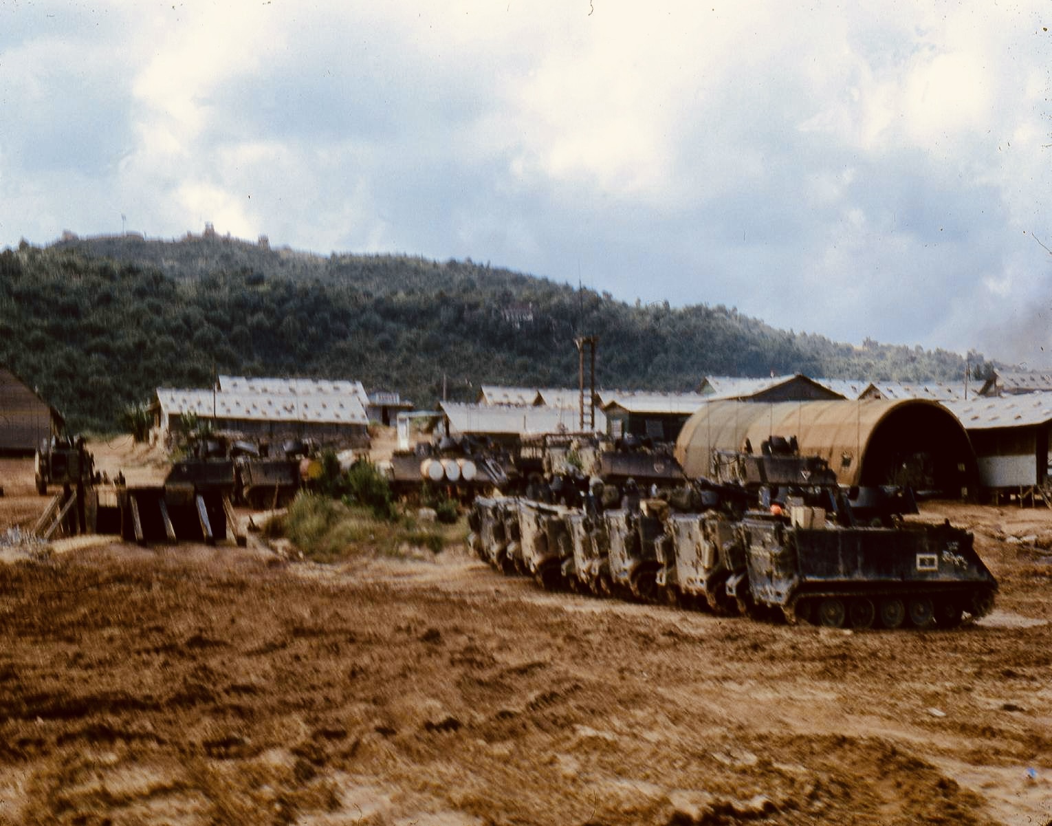 H Troop ACAVs parked near huts in the motor pool at LZ Bayonet
