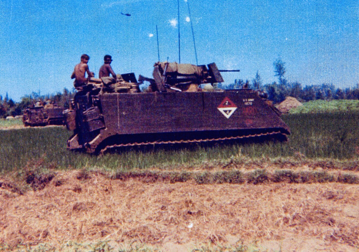 2nd Platoon’s Track 2/4 in the field, 1968, with two troopers aboard and a helicopter overhead. Troopers and location unidentified.