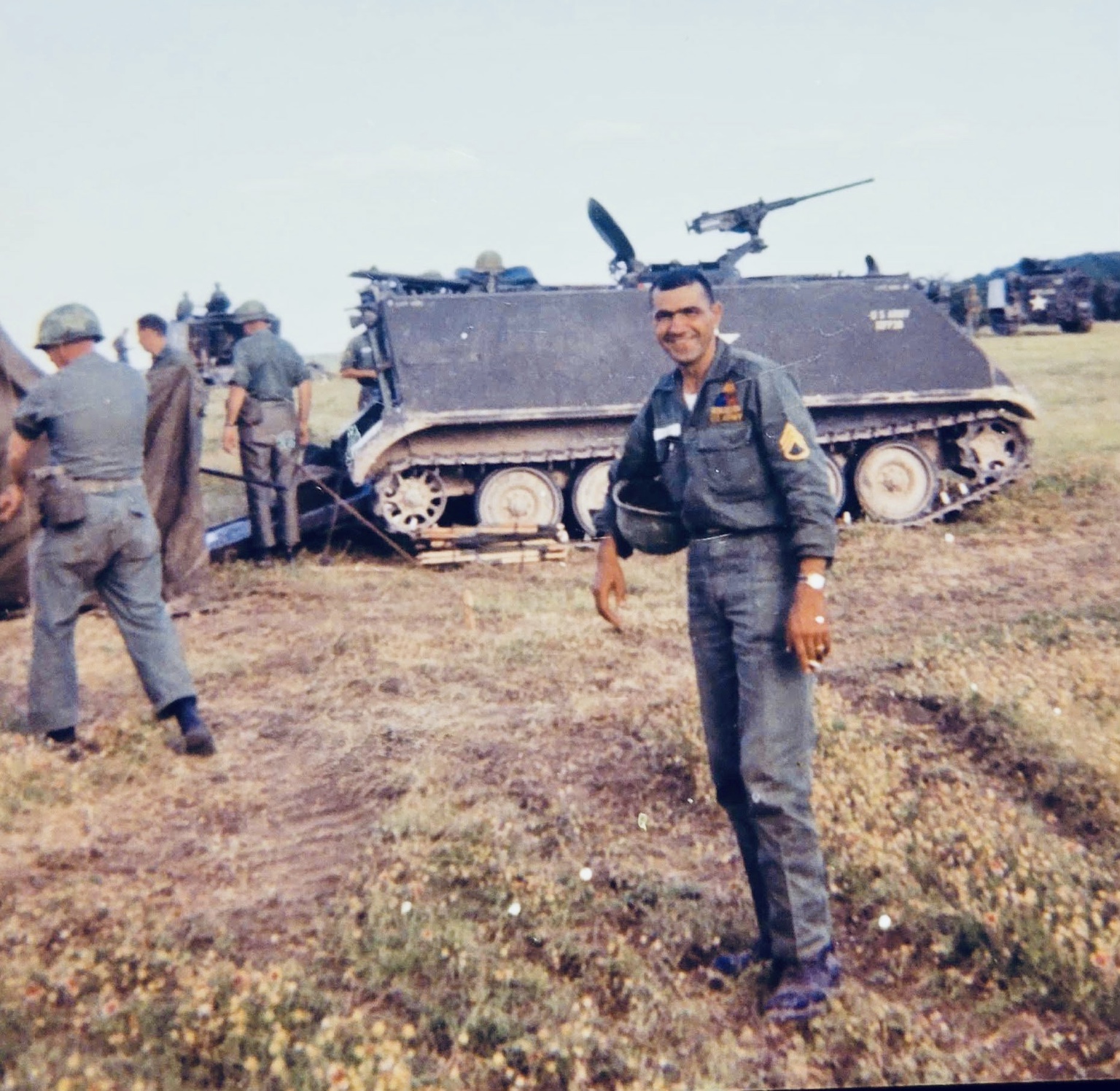 Laszlo Odie Kolonusz of 2nd Platoon standing beside a parked track