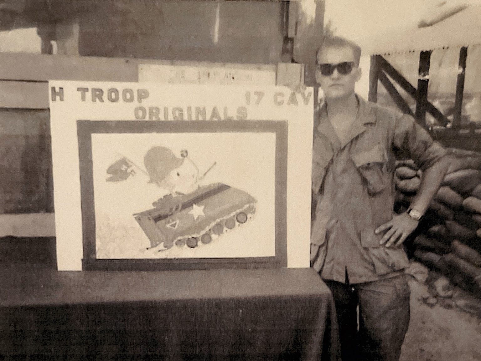 An unidentified H Trooper beside artwork marked H Troop 17 Cavalry Originals