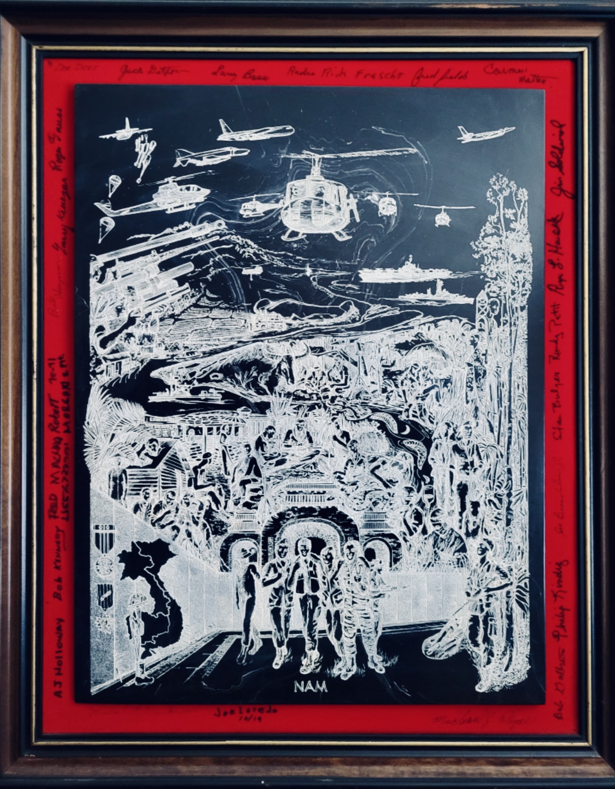 Framed Vietnam service artwork depicting aircraft, helicopters, armored vehicles, troops, and scenes of war, surrounded by signatures