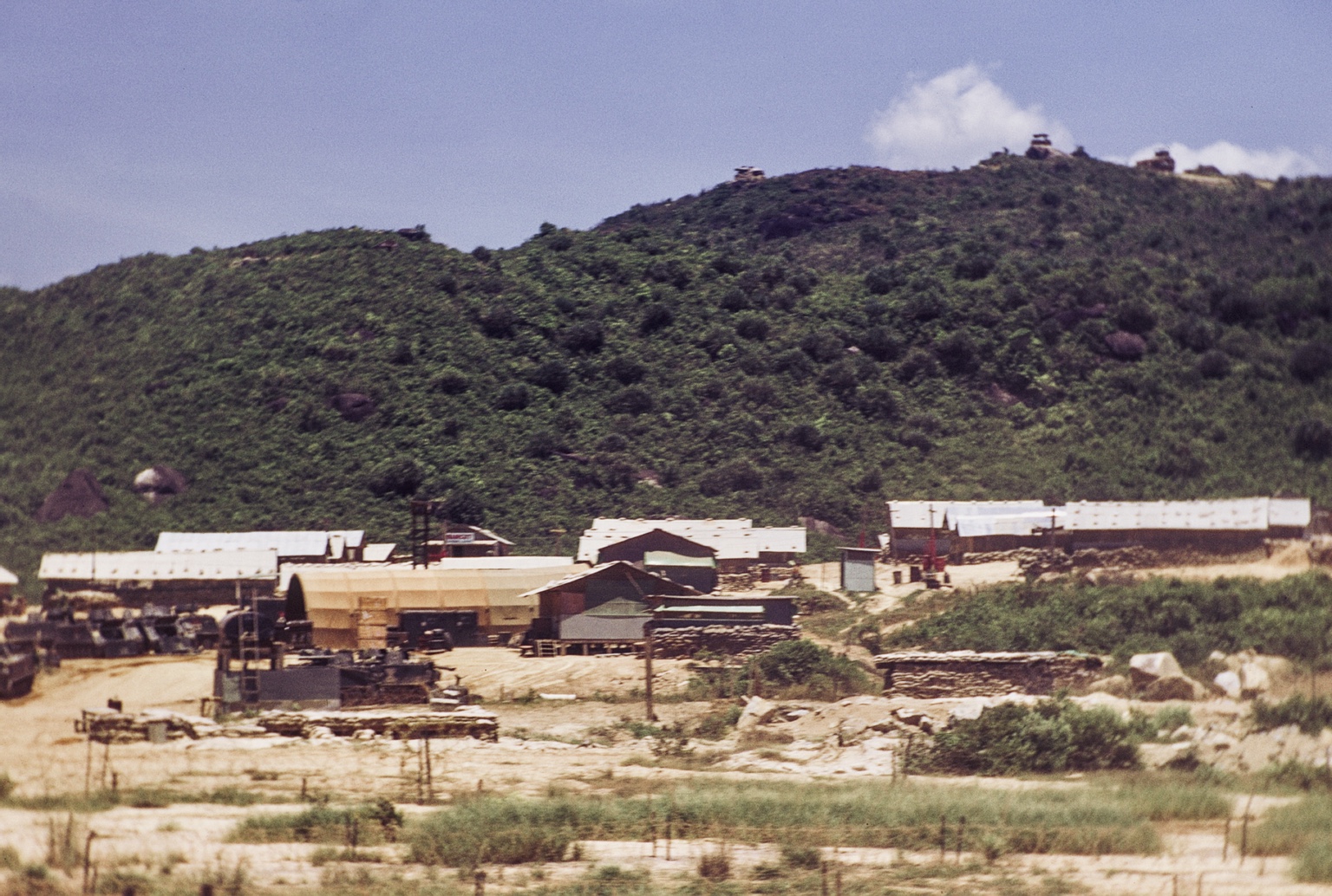 A broader view of LZ Bayonet beneath a fortified ridgeline.
